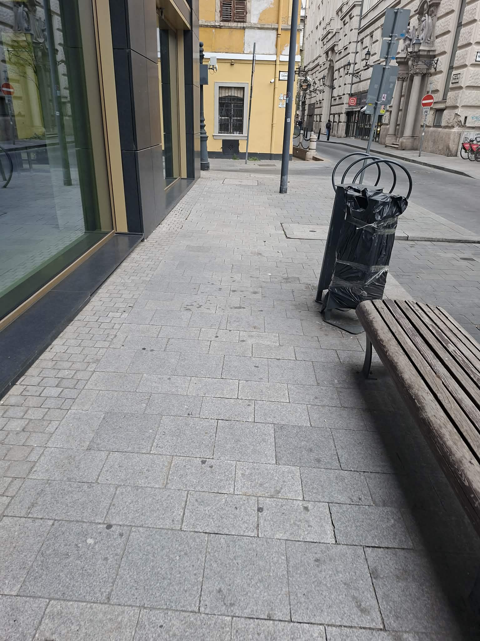 Megtisztított pad és szemetes egy bolt előtt